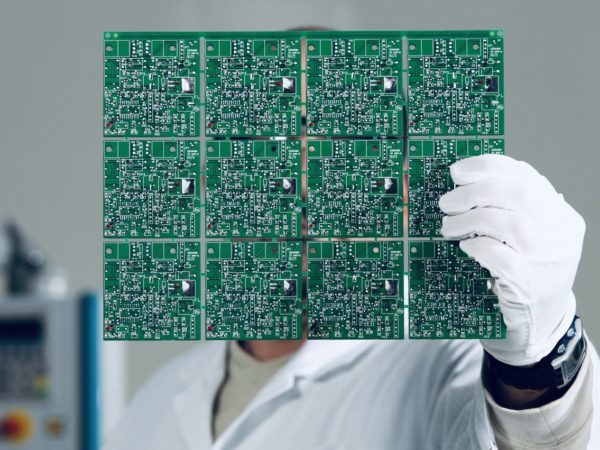 Electronics engineer controlling a circuit board